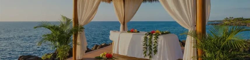 The original website’s seaside cabana, white curtains and flower-covered table